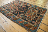 Karaja rug's indigo field showcases terra cotta geometric starbursts and floral pinwheels.