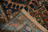 Hand-knotted Antique Karaja rug corner with low pile, visible foundation, and polychromatic side selvage.