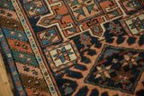 Polychromatic side cord, geometric borders, and low pile indigo field of antique Karaja rug.