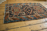 Geometric border, polychromatic selvages, and secured end of an antique Karaja rug.