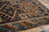 Antique Karaja rug showing low pile texture, geometric patterns, and polychromatic side selvage.