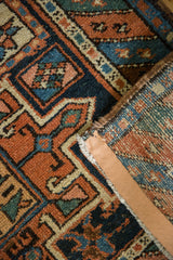 Low pile with geometric patterns in indigo, rust, ivory, and secure polychromatic selvage.