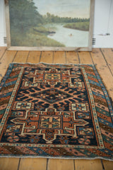 Classic triple medallion antique Karaja rug in indigo, rust, mallard green, and ivory.