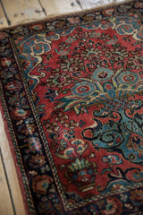 Blossomed tree of life vase motif on vintage Sarouk rug in dusty red and navy blue.