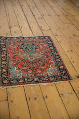 Traditional Persian Mohajeran Sarouk rug corner, dusty rose field, navy floral border, tattered ends.