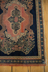 Secured fringe, indigo and blush borders, with scrolling vinery on antique Senneh rug.