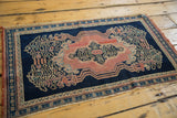 Bottom fringe and border of the antique Persian Senneh rug, revealing faint foundation wear.