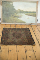 Detailed corner of Antique Kerman rug, cochineal red floral motifs, dark navy border, wear to ends.