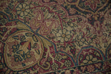 Persian Kerman rug detail, ornate red, gold, blue floral tendrils and blossoms.
