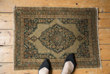 Antique Jalili Tabriz rug's corner, intricate floral spandrel in dusty dark navy and pale rust.