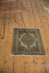 Antique Jalili Tabriz rug corner, showing dusty dark navy spandrel and intricate pale rust motifs.