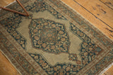 Corner detail of antique Persian Jalili Tabriz rug with floral border and secured fringe.