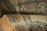 Fresh side cord and intricate dusty navy, rust border pattern on an antique Tabriz rug.