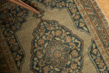 Antique Jalili Tabriz rug detail: intricate scalloped medallion, pale rust, dusty navy, and ivory.