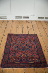 Vintage Lilihan rug corner, low pile, red field with navy floral motifs and vine border.