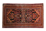Vintage Lilihan runner rug with allover floral design in dark navy, raspberry, and golden yellow.