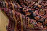 Hand-knotted Lilihan rug's low pile featuring raspberry, navy, and sky blue florals.