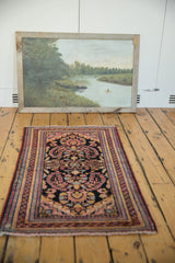 Angled view of the Lilihan rug runner’s dark navy, raspberry floral pattern and fringe.