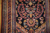 Raspberry, sky blue, saffron floral blossoms on dark navy Lilihan runner pile with visible foundation.