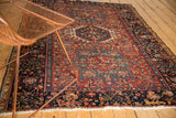 Vintage Karaja rug with intricate hook and latch medallion on a vibrant cherry red field.