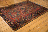 Intricate navy blue border, polychrome selvage, and fringe of a vintage Karaja rug.
