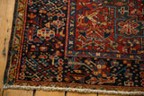 Vintage Karaja rug corner with white fringe, polychrome selvage, red and navy patterns.