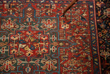 Pointer on vintage Karaja rug detail, showing serrated leaf motifs in red and green.