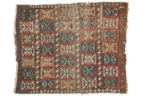 Antique Caucasian rug with oversized geometric palmette motif in cherry red, sky blue, and beige.