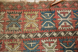 Geometric palmette pattern and texture of antique Caucasian rug, showing foundation wear.