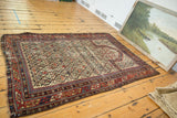 Antique Marsali Caucasian rug corner, featuring geometric borders, plant motif, and aged pile.
