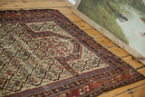 Rich red, navy, and ivory geometric plant motifs on the worn antique Caucasian Marsali rug.