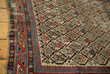 Intricate geometric motif and time-softened pile of an antique Caucasian Marsali rug.