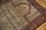 Antique Marsali rug detail showing vibrant allover plant motifs on ivory with visible threadbare regions.
