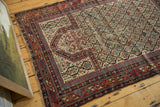 Antique Marsali Caucasian rug with red, navy geometric border and field showing threadbare areas.