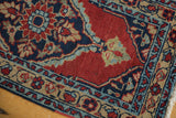 Corner of a vintage Heriz rug with geometric borders in navy, powder blue, and dusty gold.