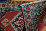Restored red side cord selvage and fringe on a folded vintage Persian Heriz rug corner.