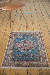 Corner of vintage Persian Tabriz mat, sky blue field, blush floral border, ivory fringe.