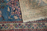Vintage Persian Tabriz rug's hand-knotted foundation, faded blue and pink floral pile.