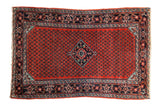 Vintage Persian Engelas rug with a central diamond medallion on a cherry red field of botehs.