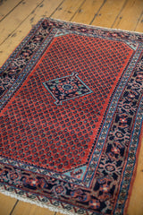 Angled perspective of a vintage Persian Engelas rug, highlighting its full pile and geometric design.
