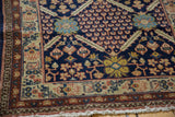 Vintage Pakistani Lahore rug detail: navy thousand flower bloom, ivory border, and fringe.