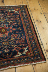 Navy and blush Herati motifs beside zig-zag and vine borders of the Borchalou rug.