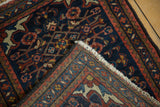 Detailed hand-knotted reverse, white fringe, and navy, red, brown Herati pattern borders of a Borchalou rug.