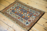 Antique Kurdish bagface rug corner detail: geometric medallion, rectilinear border, fringed edge.