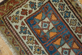 Antique Kurdish rug's geometric double medallion and rectilinear border, with sky blue, madder red, and ivory.