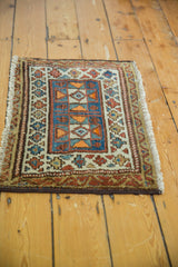 Antique Kurdish rug's secured end and fringe detail, highlighting madder root and camel patterns.