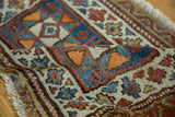Close-up of antique Kurdish rug pile, highlighting geometric patterns, sky blue, madder red, ocean green.