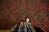 Repeating triple column gul motif in madder red and navy on vintage Ersari carpet.