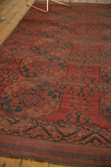 Vintage Ersari carpet's geometric border and striped kilim end in madder root red, navy.