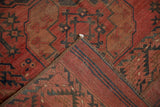 Ersari rug's hand-knotted foundation, restored kilim end, and deep red geometric motifs.